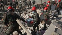 عمال الإنقاذ يرفعون أنقاض مبنى سكني مدمر في مدينة كنجة الأذرية بحثا عن ناجين